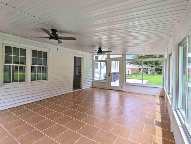 unfurnished sunroom with ceiling fan