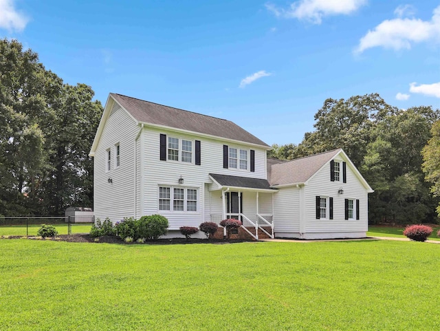 colonial house featuring a front lawn