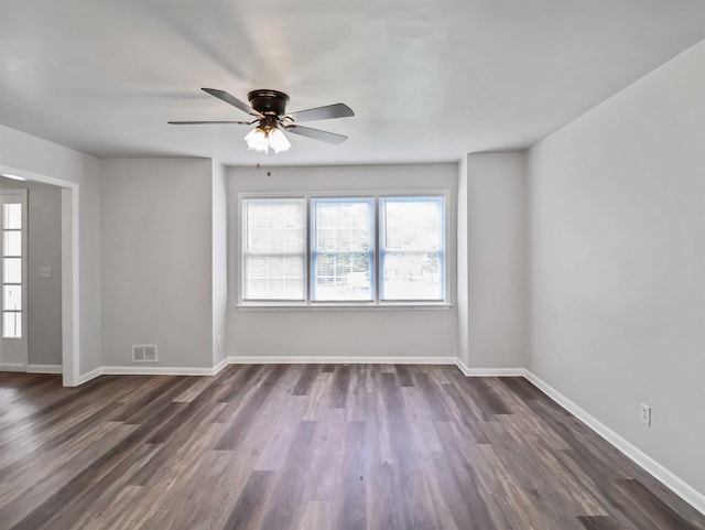 unfurnished room featuring ceiling fan and dark hardwood / wood-style floors