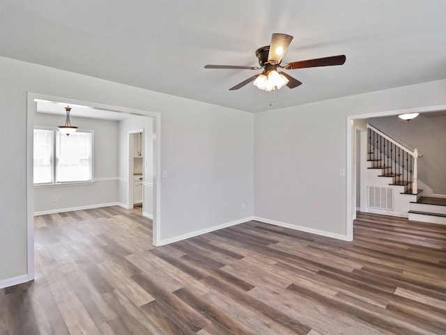 empty room featuring dark hardwood / wood-style floors and ceiling fan