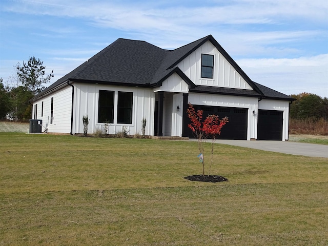 modern farmhouse style home with a garage, a front lawn, and central air condition unit