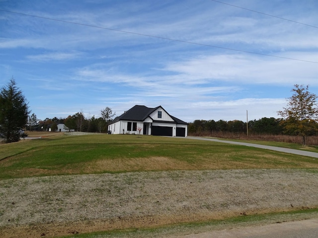 single story home featuring a front yard, an outbuilding, and a garage