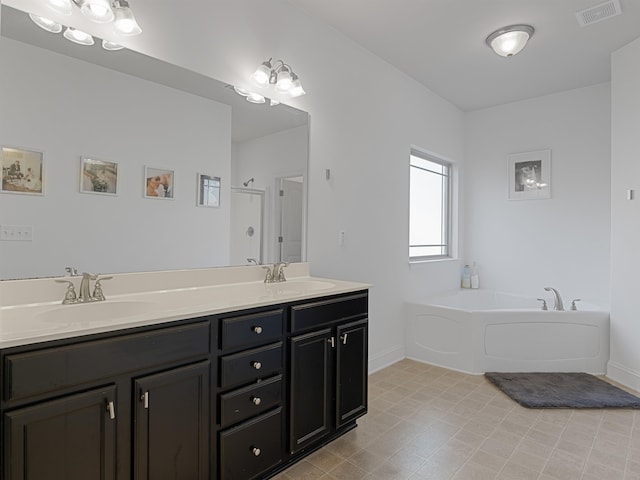 bathroom with vanity and independent shower and bath