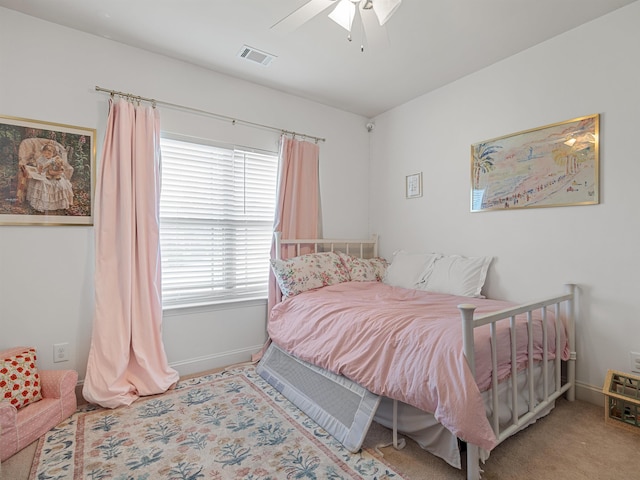 bedroom featuring light colored carpet and ceiling fan