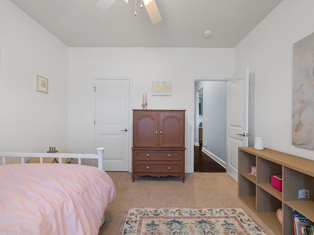 bedroom featuring ceiling fan and light carpet