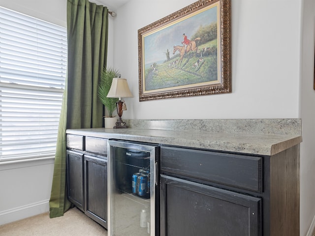 interior details with carpet flooring, wine cooler, and bar