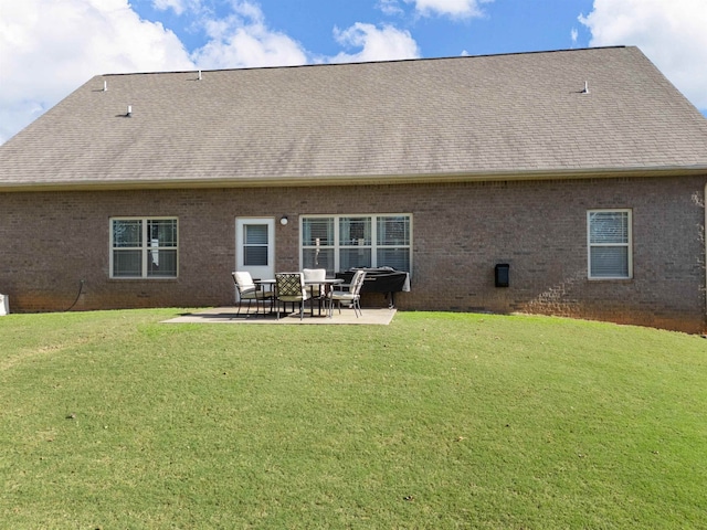 rear view of house featuring a patio area and a lawn