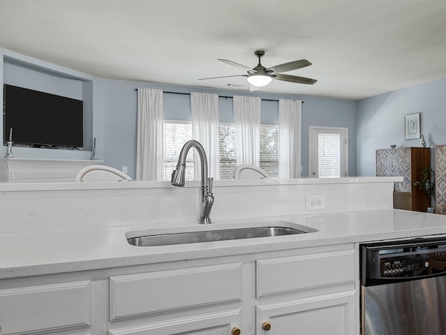 kitchen with white cabinetry, dishwasher, light stone counters, and sink