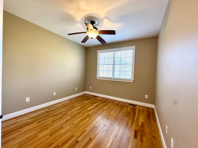 unfurnished room with ceiling fan and wood-type flooring