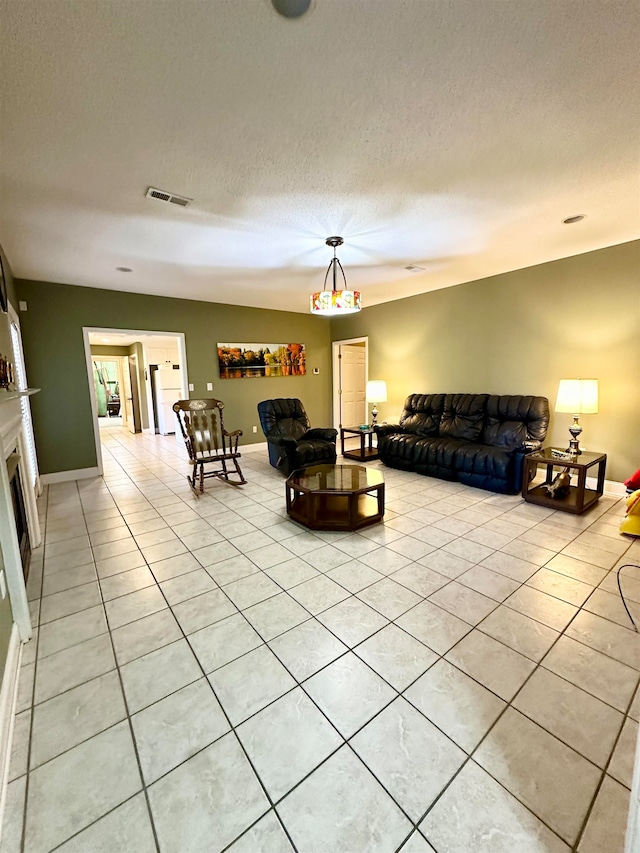 living room with light tile patterned floors and a textured ceiling