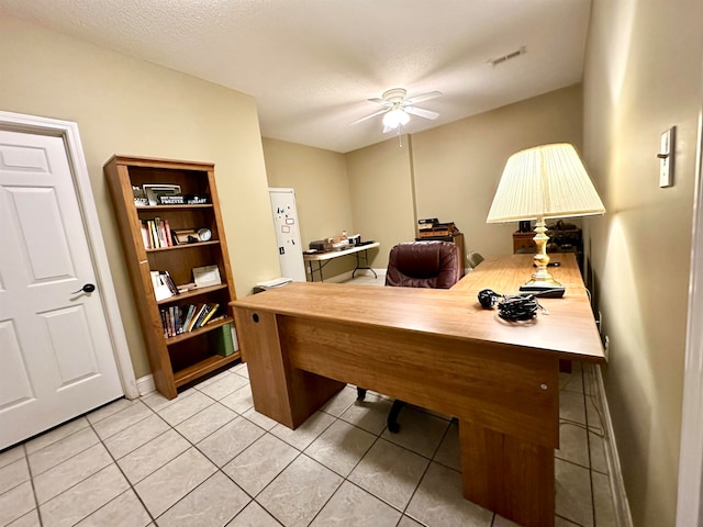 office featuring light tile patterned floors, a textured ceiling, and ceiling fan