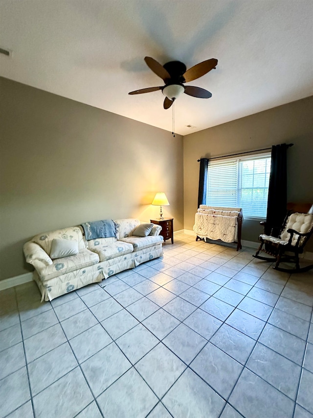 unfurnished living room featuring ceiling fan and light tile patterned floors