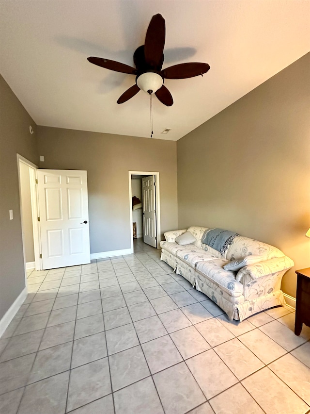 unfurnished living room featuring ceiling fan and light tile patterned floors