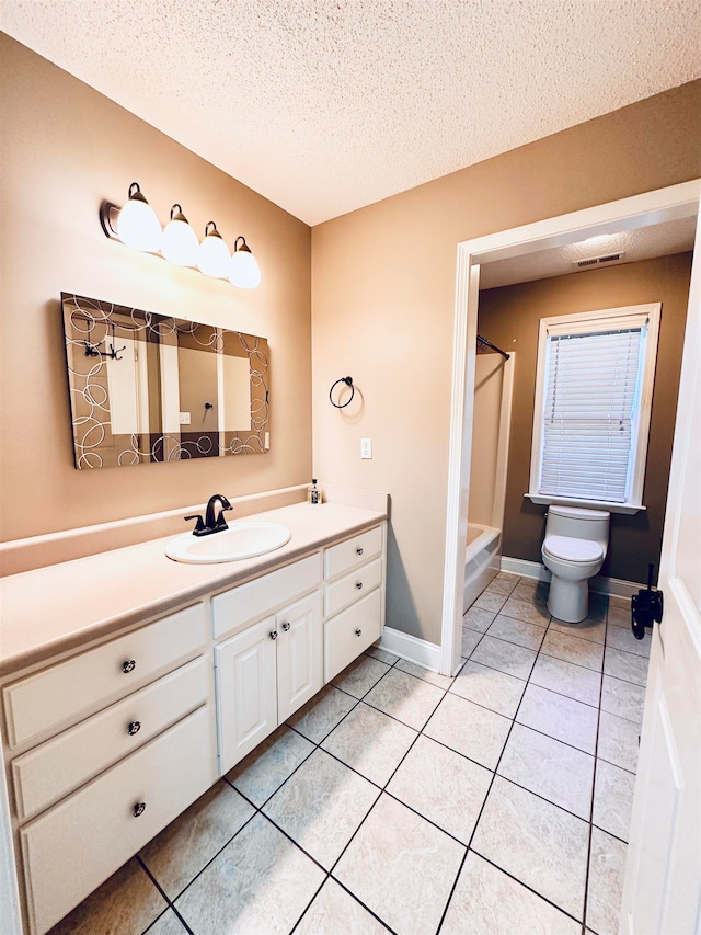 bathroom featuring walk in shower, tile patterned floors, a textured ceiling, toilet, and vanity