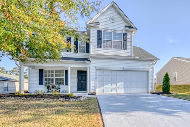 view of property with a front lawn and a garage