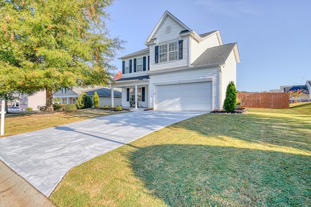 view of property featuring a garage and a front yard