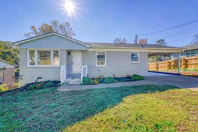 ranch-style home featuring a front yard and a carport