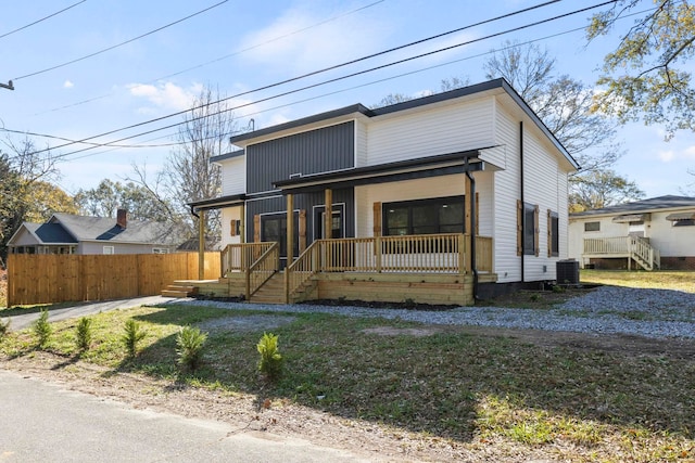 view of front of house with covered porch and central AC unit