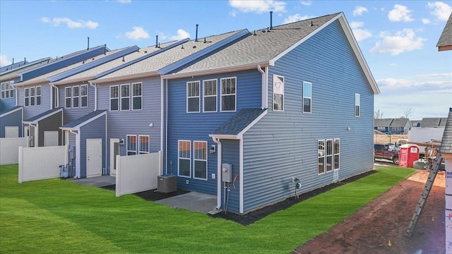 rear view of house featuring a yard