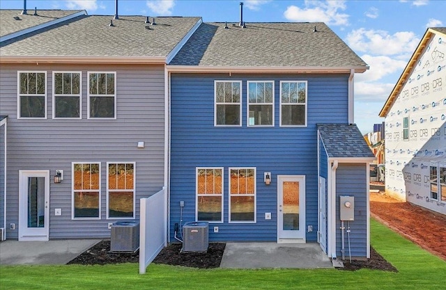 back of house with a lawn, a patio area, and central air condition unit