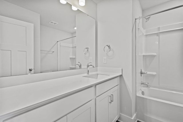 bathroom featuring vanity and tub / shower combination