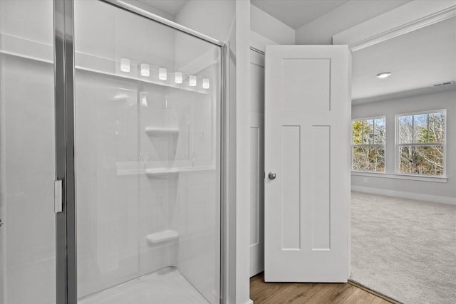 bathroom with walk in shower and hardwood / wood-style flooring