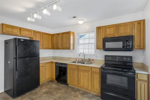 kitchen with sink, rail lighting, black appliances, and a textured ceiling