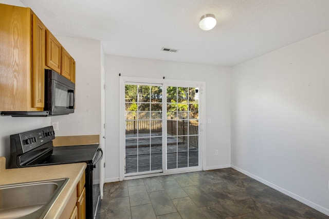 kitchen with black appliances, sink, and a textured ceiling