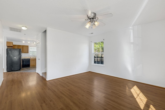 spare room featuring hardwood / wood-style floors, a textured ceiling, ceiling fan, and sink