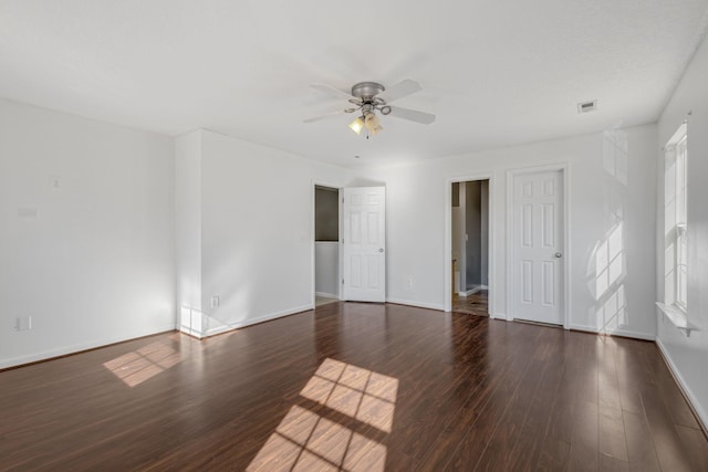 empty room with ceiling fan and dark wood-type flooring