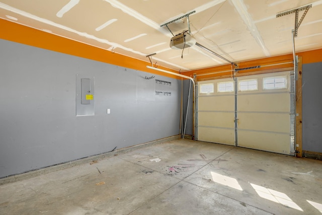 garage with electric panel and a garage door opener