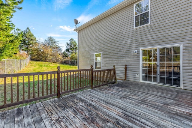 wooden terrace featuring a lawn