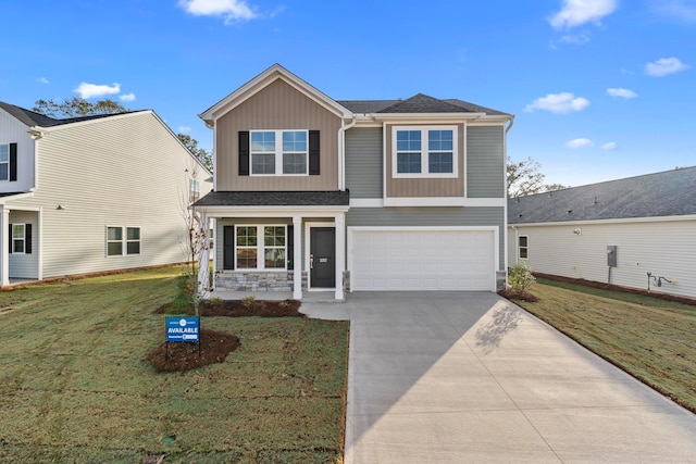 view of front of home with a porch, a garage, and a front yard