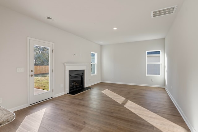 unfurnished living room featuring hardwood / wood-style flooring