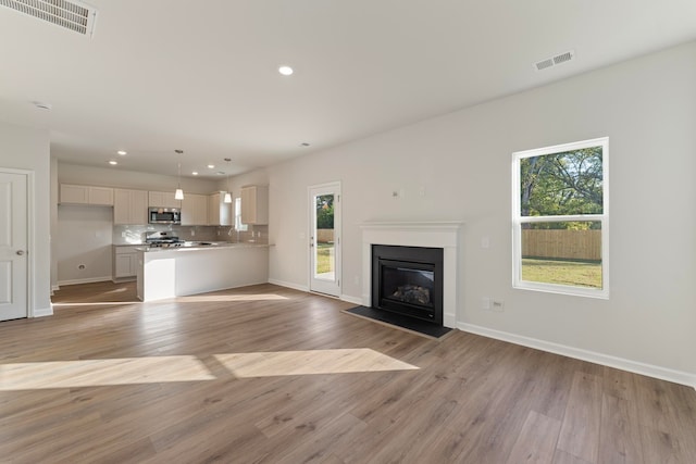 unfurnished living room with light hardwood / wood-style flooring