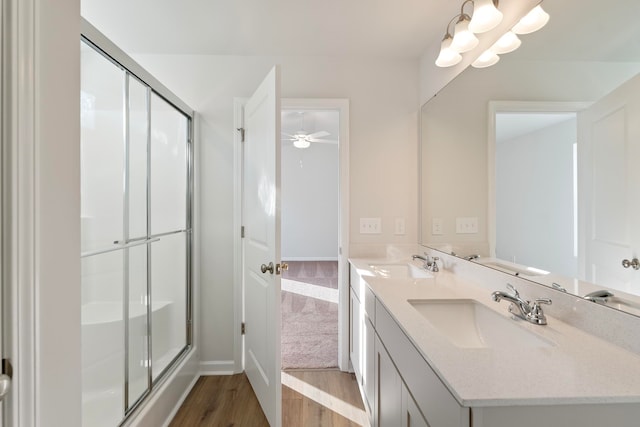 bathroom with wood-type flooring, vanity, walk in shower, and ceiling fan