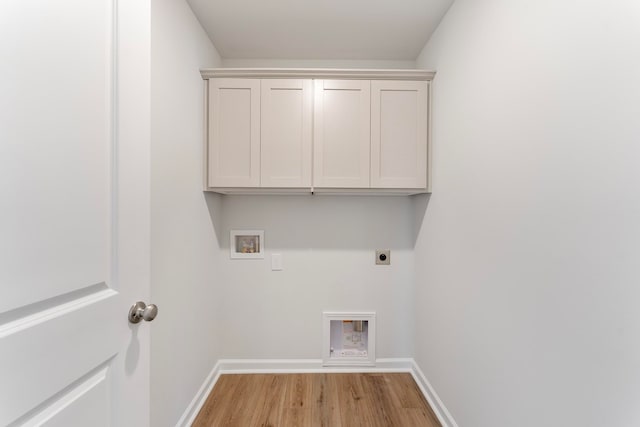 laundry area with cabinets, hookup for a washing machine, light wood-type flooring, and electric dryer hookup