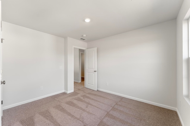 empty room featuring light colored carpet