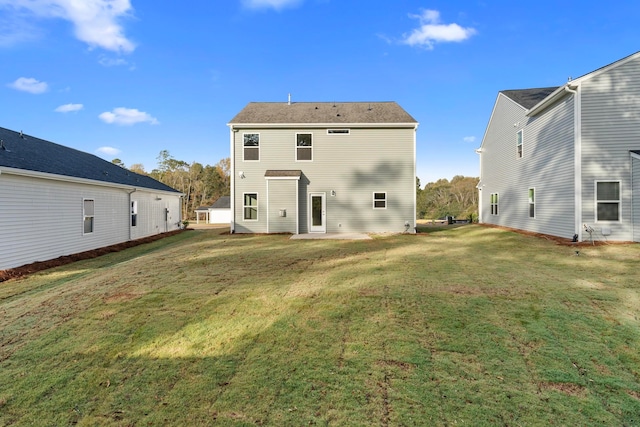 rear view of house with a yard and a patio