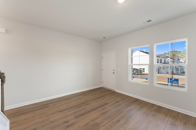 spare room with dark wood-type flooring