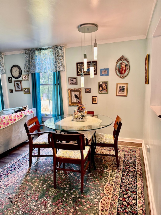 dining area featuring hardwood / wood-style flooring and ornamental molding