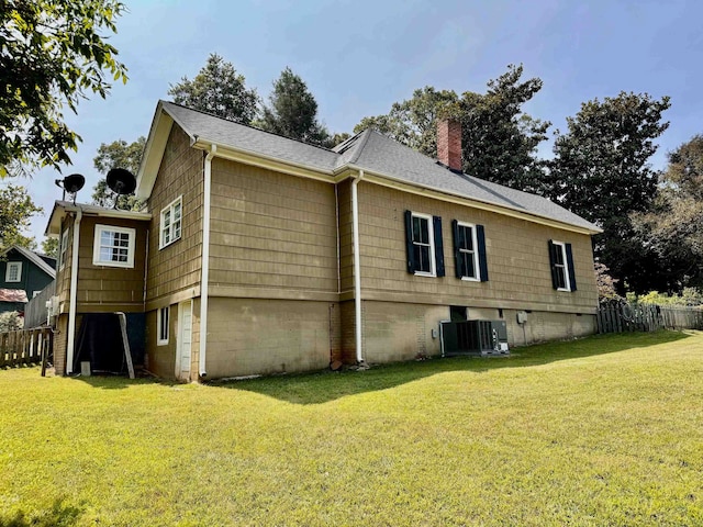 view of property exterior with a yard and central AC unit