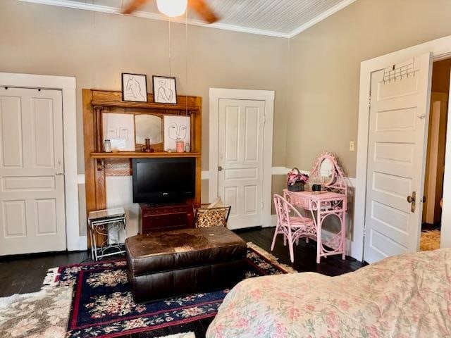 interior space with dark hardwood / wood-style floors, ceiling fan, and ornamental molding