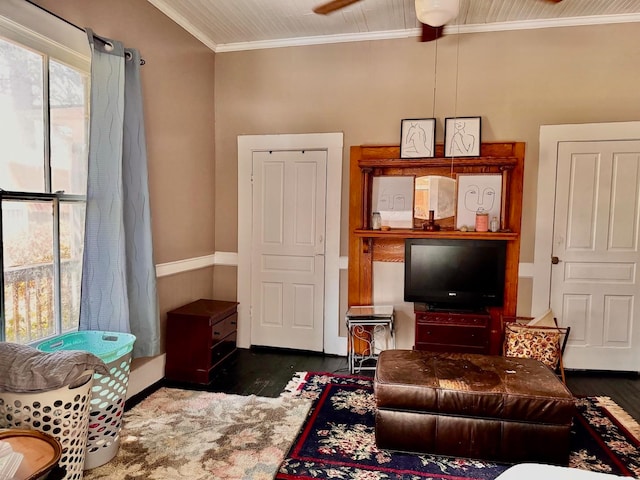 living room featuring ceiling fan, crown molding, and dark wood-type flooring