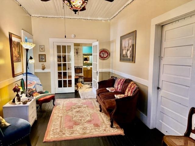 living area featuring french doors, dark hardwood / wood-style flooring, and ceiling fan