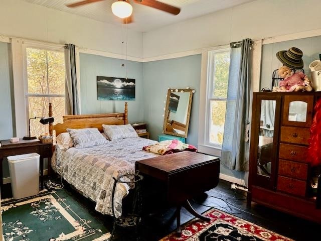 bedroom featuring ceiling fan and dark wood-type flooring