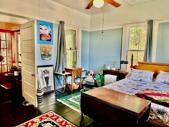 bedroom with ceiling fan and dark hardwood / wood-style flooring