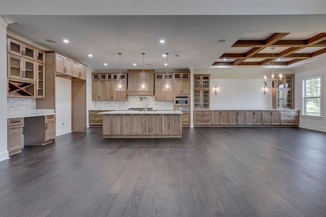 kitchen featuring a center island with sink, dark hardwood / wood-style floors, and decorative light fixtures