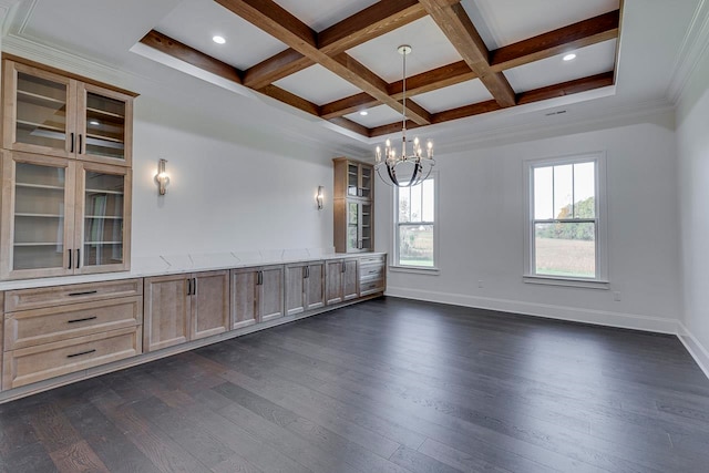 empty room with dark wood-type flooring, coffered ceiling, beamed ceiling, a notable chandelier, and crown molding