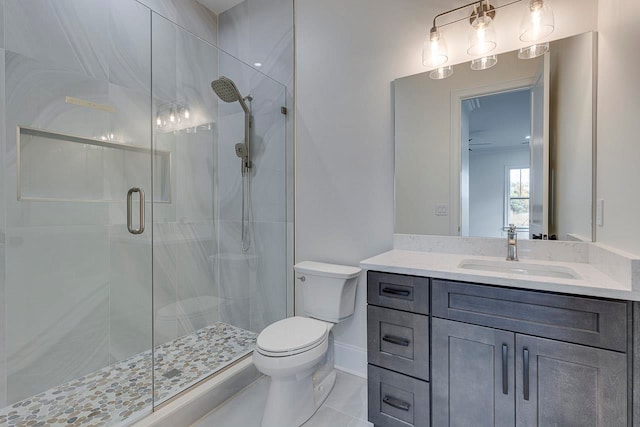 bathroom with vanity, toilet, and an enclosed shower